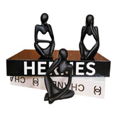 Home Sajawat set of three black abstract thinker statues displayed on decorative books for modern home decor.