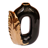 Home Sajawat modern black ceramic vase with a metallic gold feather accent and a unique open-center silhouette.