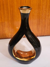 Home Sajawat modern ceramic tabletop vase with a glossy black exterior and reflective gold interior cutout design.