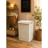 Home Sajawat cream corduroy rectangular laundry hamper with lid and metal grommets in a cozy modern bedroom setting.