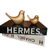 Home Sajawat set of two matte gold bird figurines displayed on top of decorative designer books.
