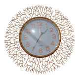 Home Sajawat gold metal wall clock with intricate branch design and white face with Arabic numerals.