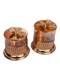 Home Sajawat glass storage jars with gold lattice metalwork and floral lids on a white surface