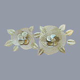 Home Sajawat set of two gold metal floral wall art decorations with intricate leaf details.
