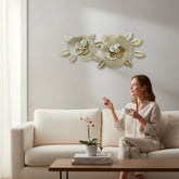 Home Sajawat gold metal flower wall art sculpture with textured centers and metallic leaves. Two openwork floral designs.