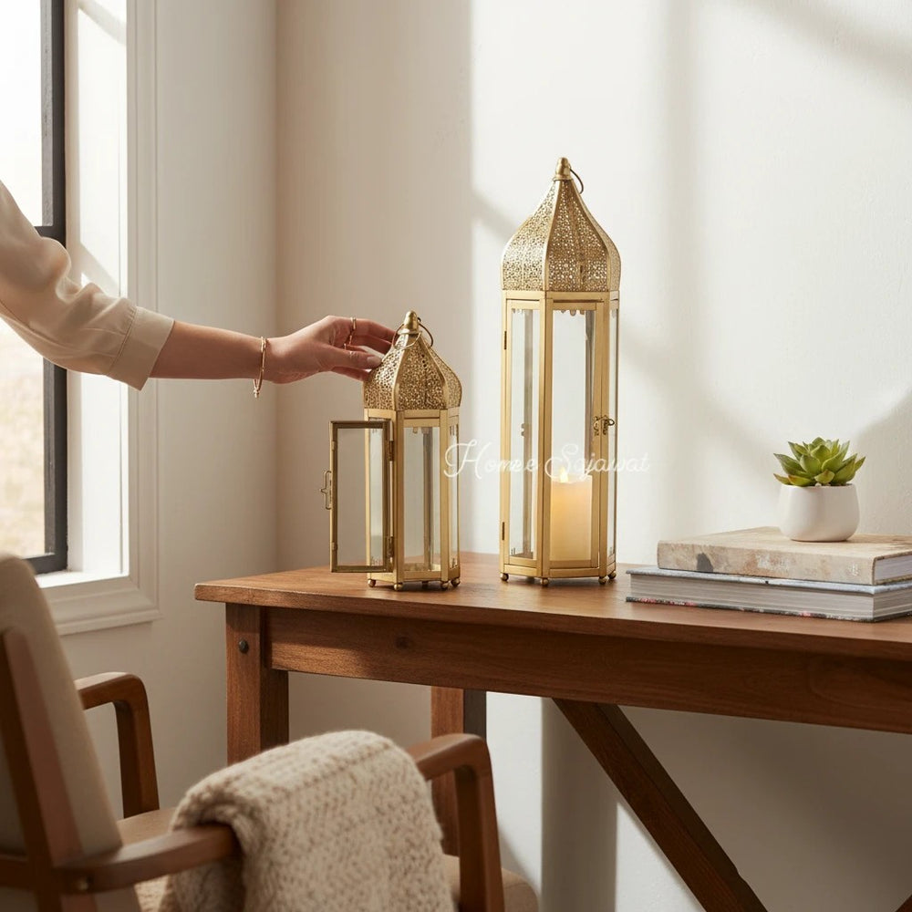 Home Sajawat gold metal Moroccan-style lanterns with intricate cut-outs and glass panels. Set of two.