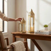 Home Sajawat gold metal Moroccan-style lanterns with intricate cut-outs and glass panels. Set of two.