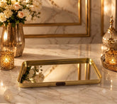 Home Sajawat rectangular mirrored vanity tray with a polished gold-tone metal frame and HOME label on a marble table.