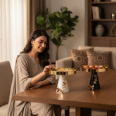 Home Sajawat decorative gold tray stand with butterfly accents on conical base in white or black.