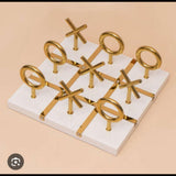 Home Sajawat luxury white Tic Tac Toe game board with gold accents and metal X O pieces.