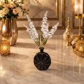 Home Sajawat matte black circular vase with white floral arrangement on a marble table with gold accents