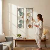 Home Sajawat set of two metal lily pad wall art panels in teal, silver, gold, and copper tones with openwork design.