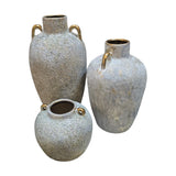Home Sajawat set of three grey-blue textured ceramic amphora vases with gold handles and rims.