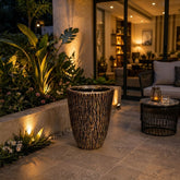 Home Sajawat decorative outdoor planter with a textured bark-like finish on a modern patio at night.