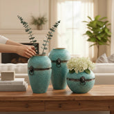 Home Sajawat set of three turquoise textured ceramic vases with lion ring accents and antiqued metal bands.