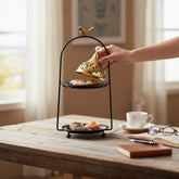 Home Sajawat gold two-tier incense burner with bird accent, crystal finial, and cut-out lids. Black stand.
