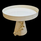 Home Sajawat creamy white cake stand with gold leaf embellishments on pedestal base and raised rim.