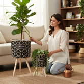 Home Sajawat set of 2 black and natural woven raffia planters with wooden legs and "Flowers" patch.