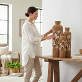 Home Sajawat set of three coastal jute rope floor vases with white woven lattice detail on a rustic wooden console table.