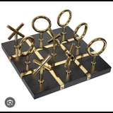 Home Sajawat luxury black Tic Tac Toe game board with gold accents and polished metal X and O pieces.