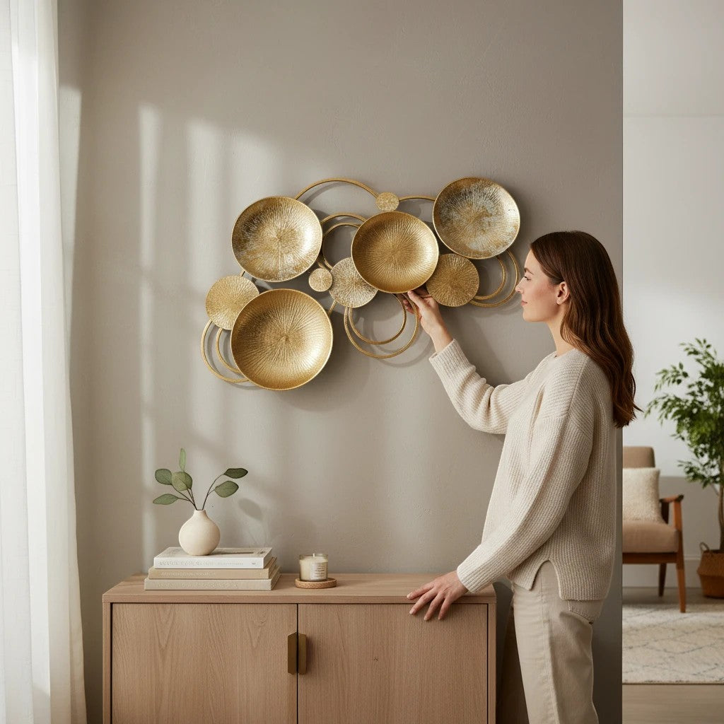 Home Sajawat abstract metal wall art sculpture with gold circular discs and silver accents. Textured surfaces and loops create movement.