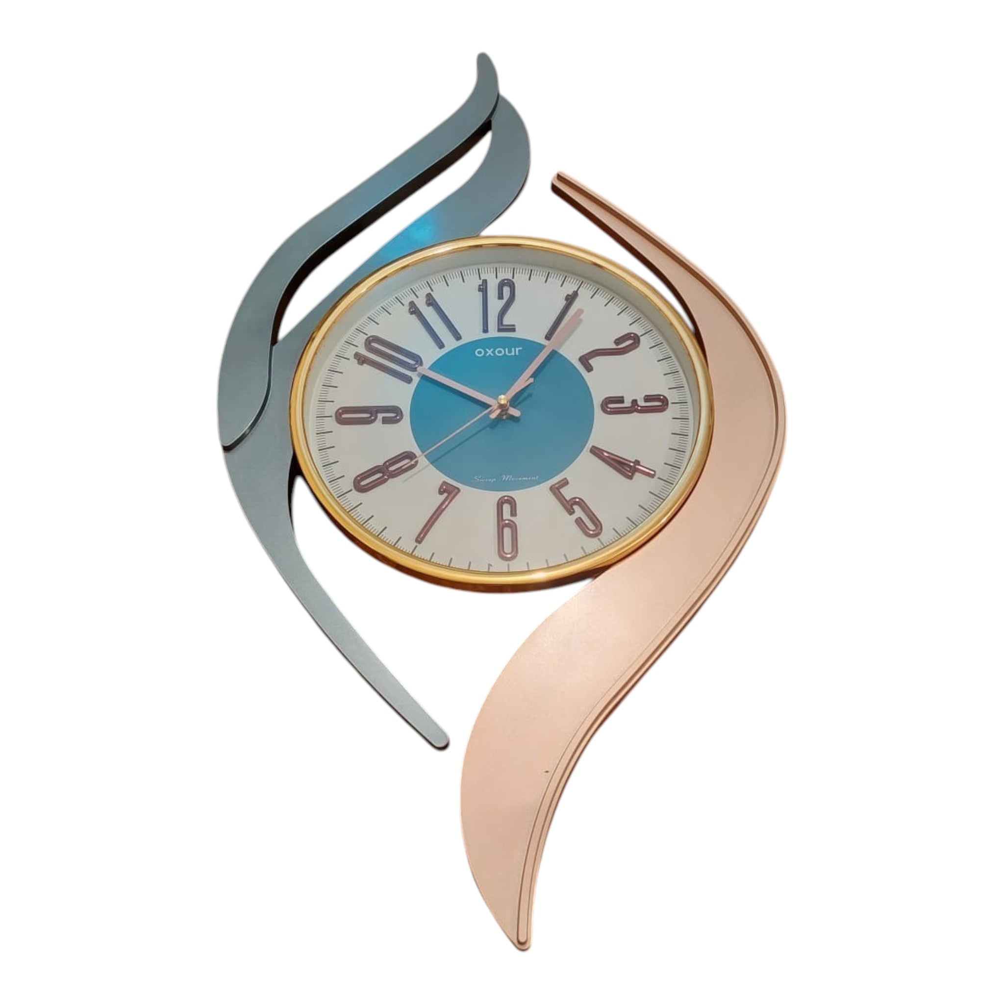 Home Sajawat modern abstract wall clock with teal face, gold bezel, and swirling grey and rose gold accents. Arabic numerals.