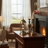 Home Sajawat antique brass table clock with Roman numerals and emerald cap, plus two candelabras with teal accents.