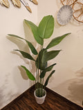 Home Sajawat artificial Bird of Paradise floor plant with large green leaves in a textured grey pot for home decor.