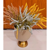 Home Sajawat artificial floral arrangement with pink, blue, and yellow stems in a beige bowl with a gold pedestal base