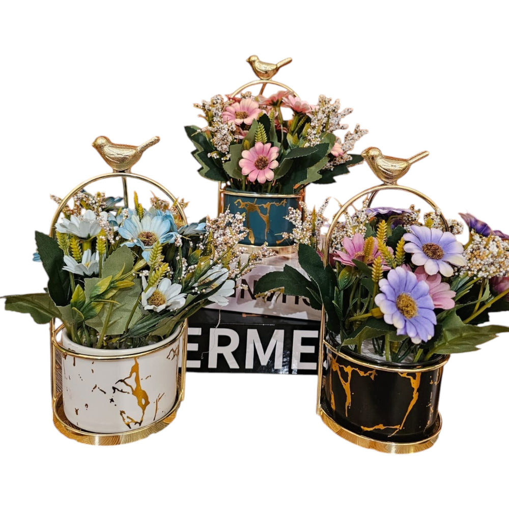 Home Sajawat artificial flower set in marble-effect ceramic pots with gold bird accents and metal stands.