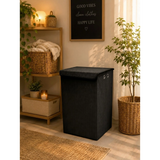 Home Sajawat black corduroy rectangular laundry hamper with lid and metal grommets in a cozy modern living space.