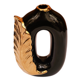 Home Sajawat modern ceramic vase in glossy black with a metallic gold feather accent and unique open-center design.