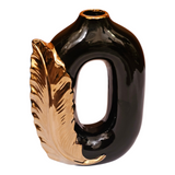 Home Sajawat modern black ceramic vase with a metallic gold feather accent and a unique open-center silhouette.