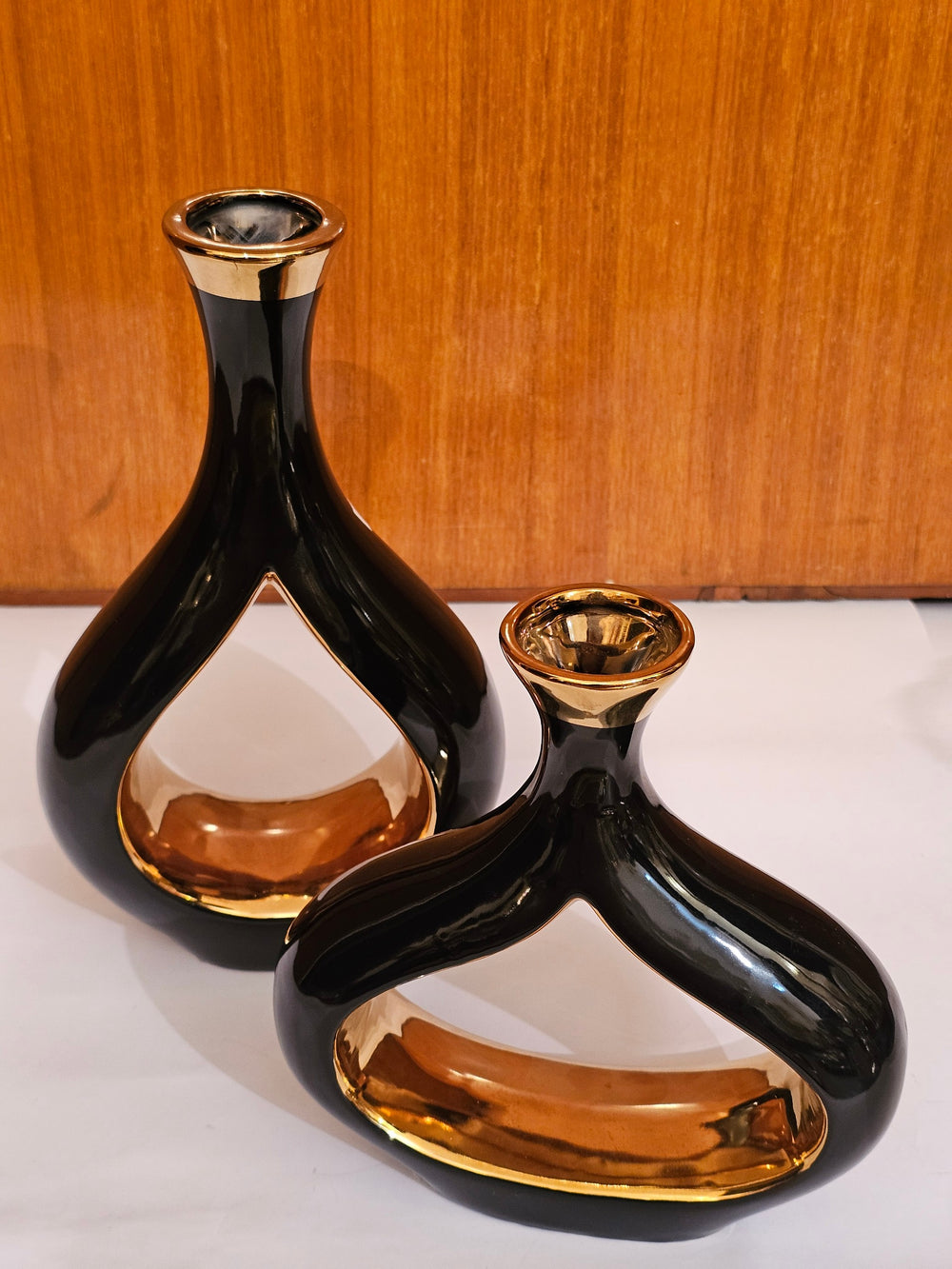 Home Sajawat modern ceramic vase set with glossy black exterior and reflective gold interior in sculptural shapes.