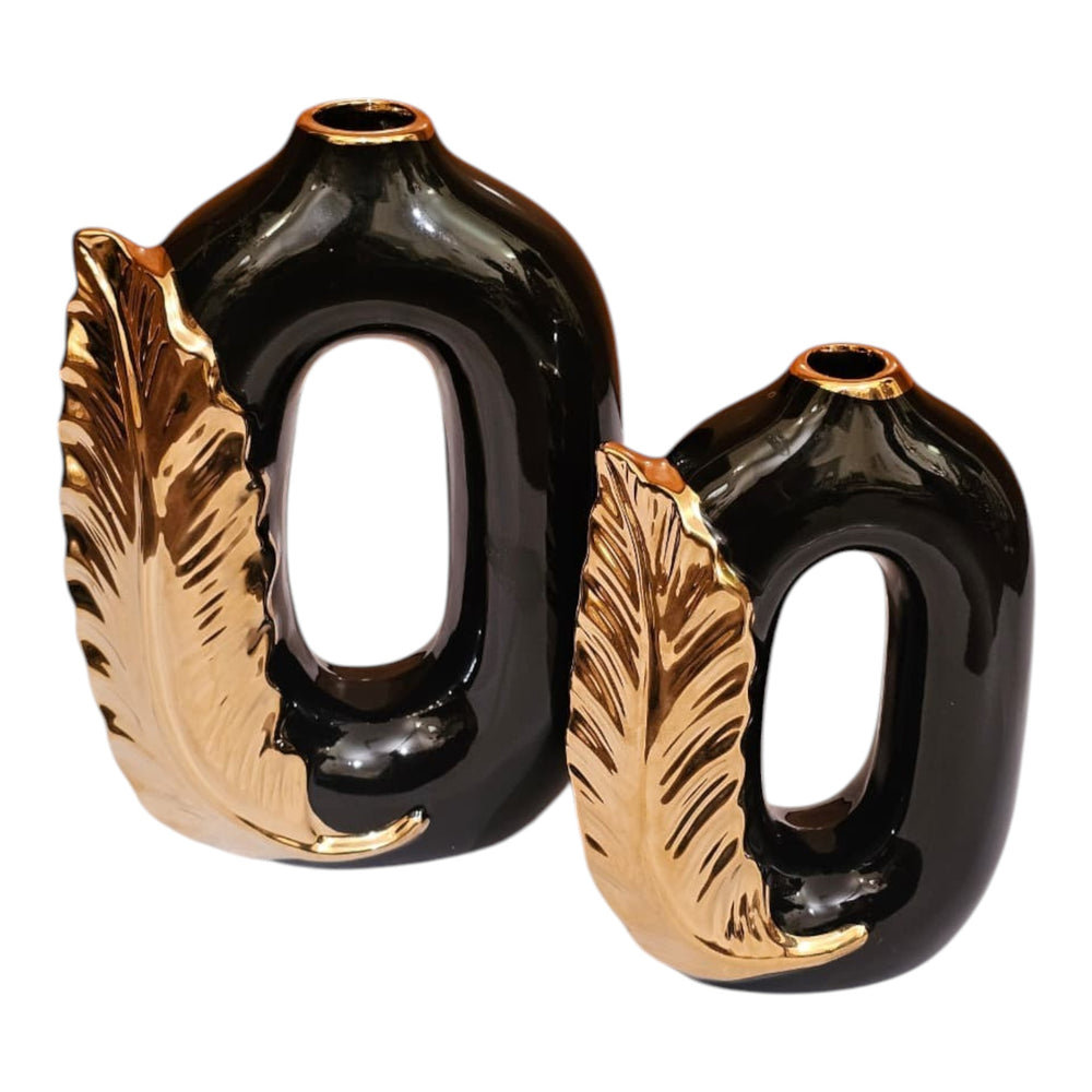 Home Sajawat set of two black ceramic vases with metallic gold leaf accents and a modern hollow oval design.