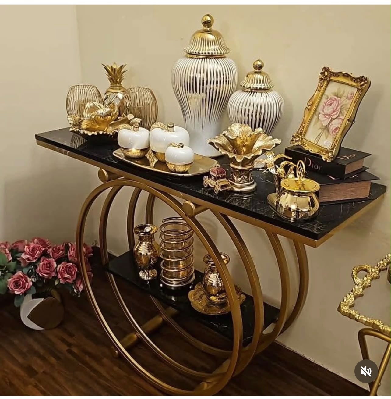 Home Sajawat modern console table with black marble-effect shelves and a gold metal circular frame, styled with decor.