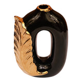 Home Sajawat decorative ceramic vase in glossy black with a metallic gold leaf accent and hollow oval silhouette.