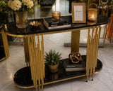 Home Sajawat modern console table with black marble-effect shelves and a gold metal frame in a stylish entryway.