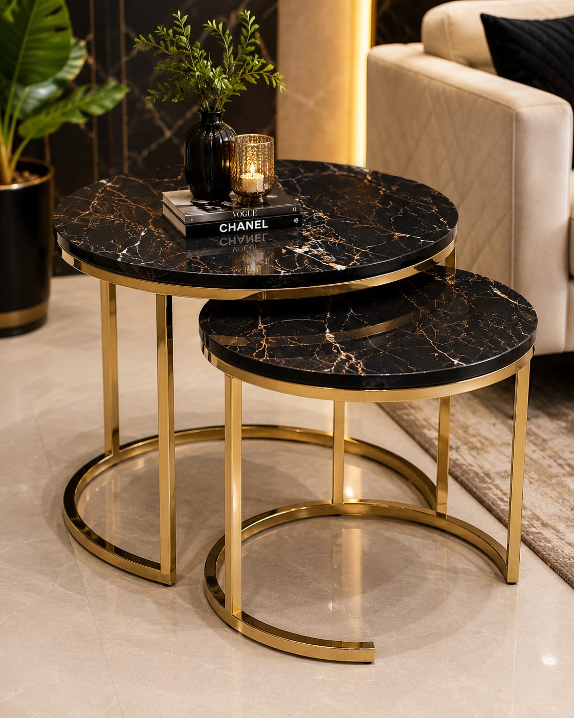 Home Sajawat round nesting coffee tables with black faux marble tops and gold metal frames in a modern living room.