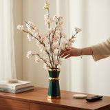 Home Sajawat artificial cherry blossom arrangement with pink flowers in a geometric emerald green and gold ceramic vase.