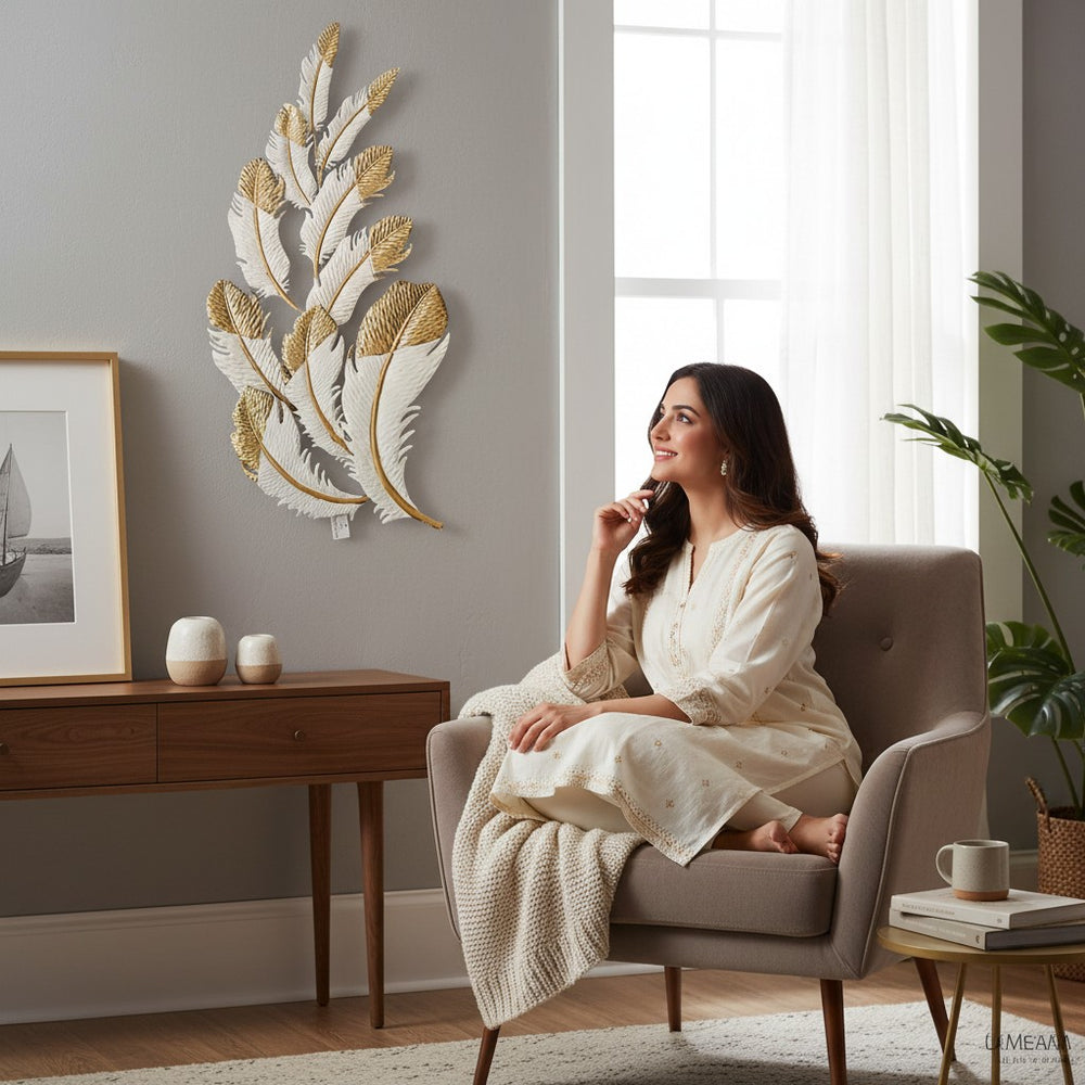 Home Sajawat white and gold metal feather wall art sculpture with intricate detailing.