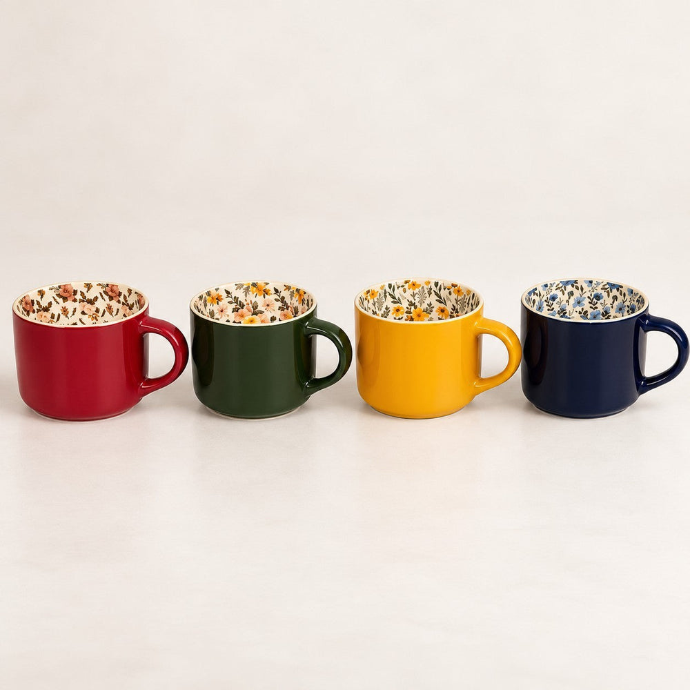 Home Sajawat set of four ceramic coffee mugs with solid exterior colors and interior floral botanical patterns.
