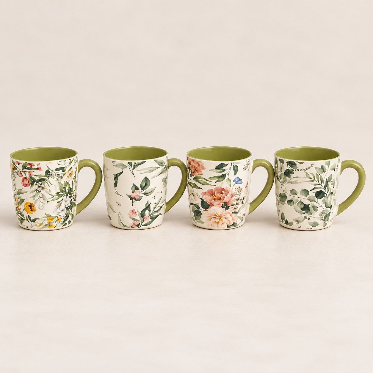 Home Sajawat ceramic coffee mug set featuring four mugs with unique floral botanical patterns and green interiors.