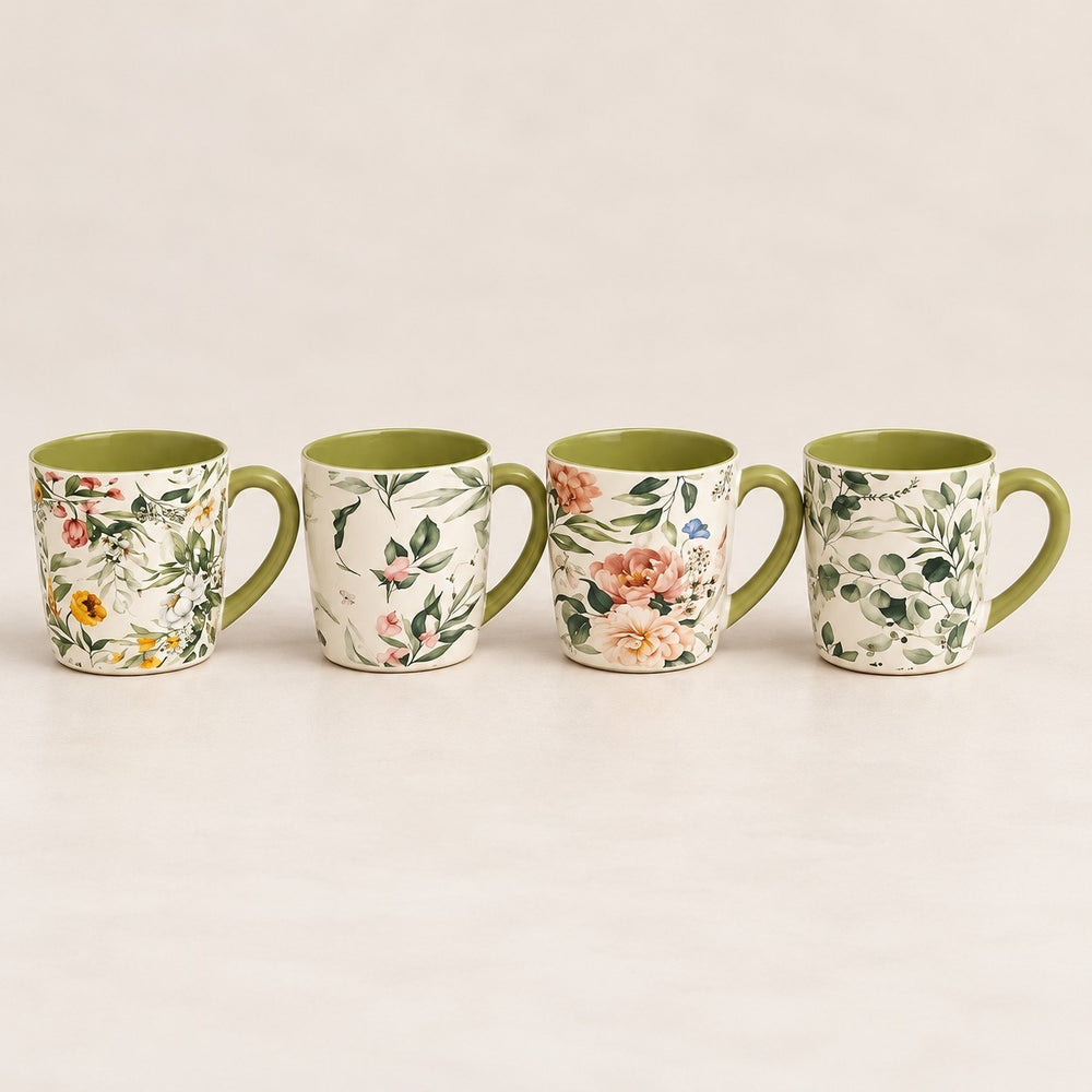 Home Sajawat ceramic coffee mug set featuring four mugs with unique floral botanical patterns and green interiors.