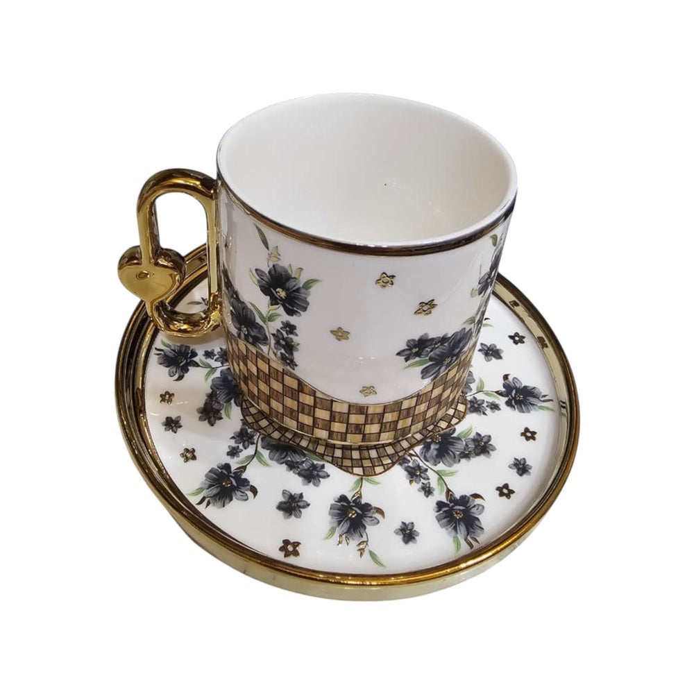 Home Sajawat decorative ceramic coffee cup and saucer set with charcoal floral pattern and gold accents. Features a gold heart handle.