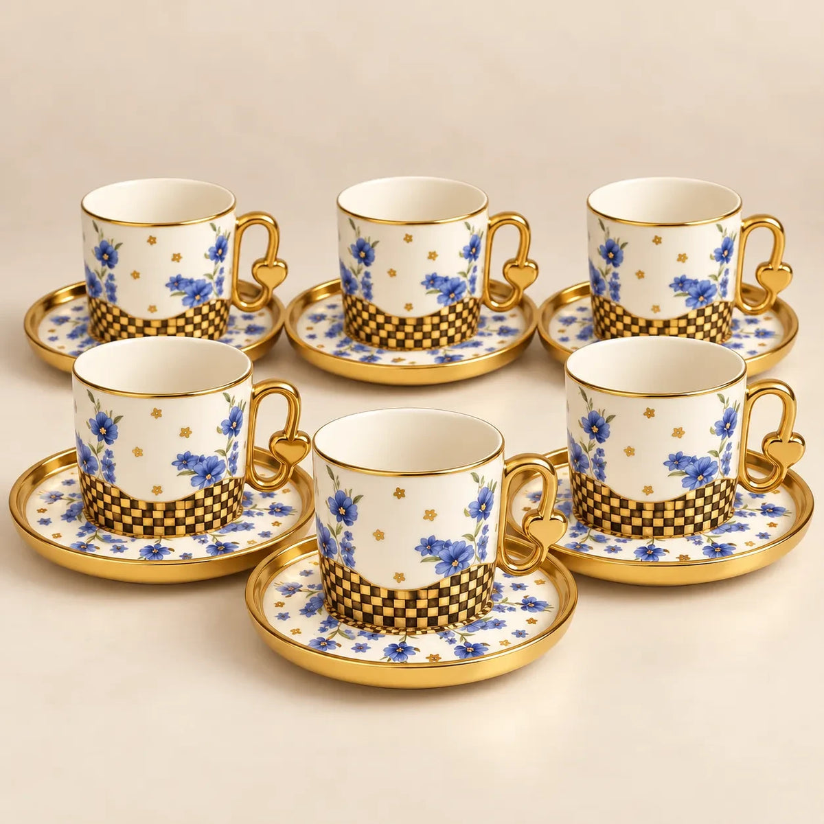 Home Sajawat porcelain tea cup and saucer set with blue floral patterns, gold rims, and heart-shaped handles.