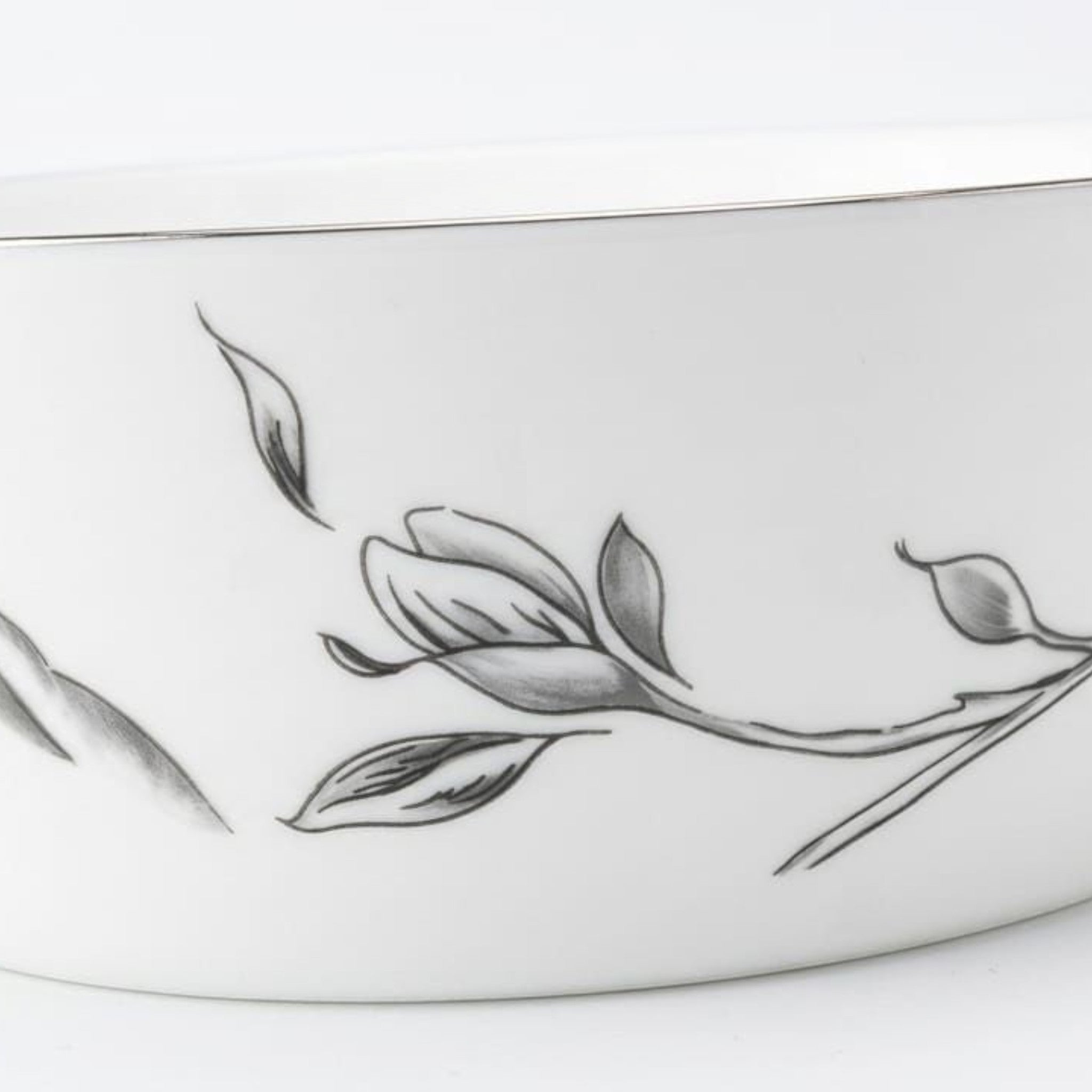 Home Sajawat white porcelain serving platter with a delicate floral design and a thin silver rim.