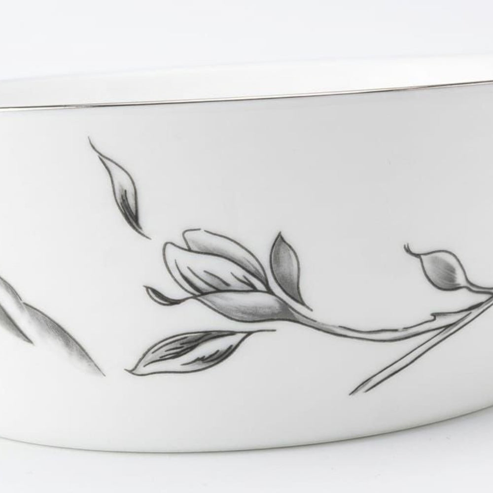 Home Sajawat white porcelain serving platter with a delicate floral design and a thin silver rim.