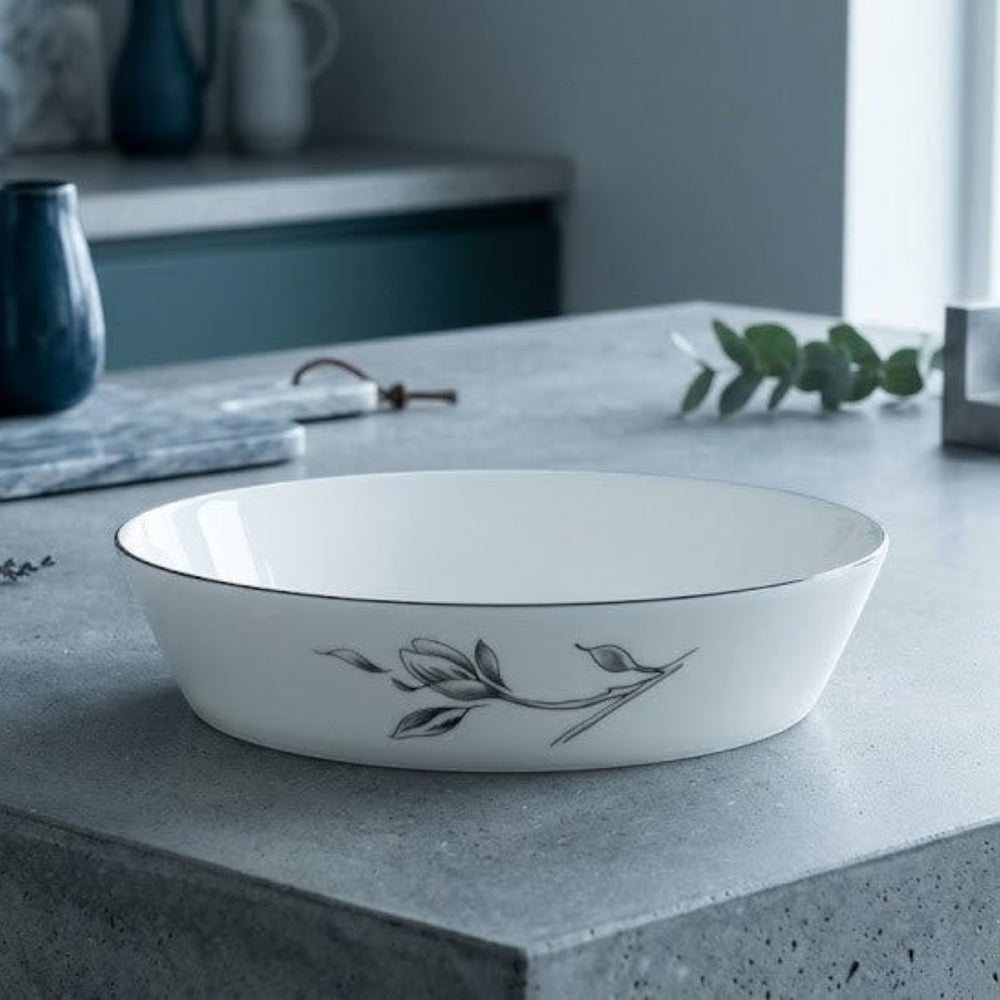 Home Sajawat white porcelain serving platter with floral design and black trim.