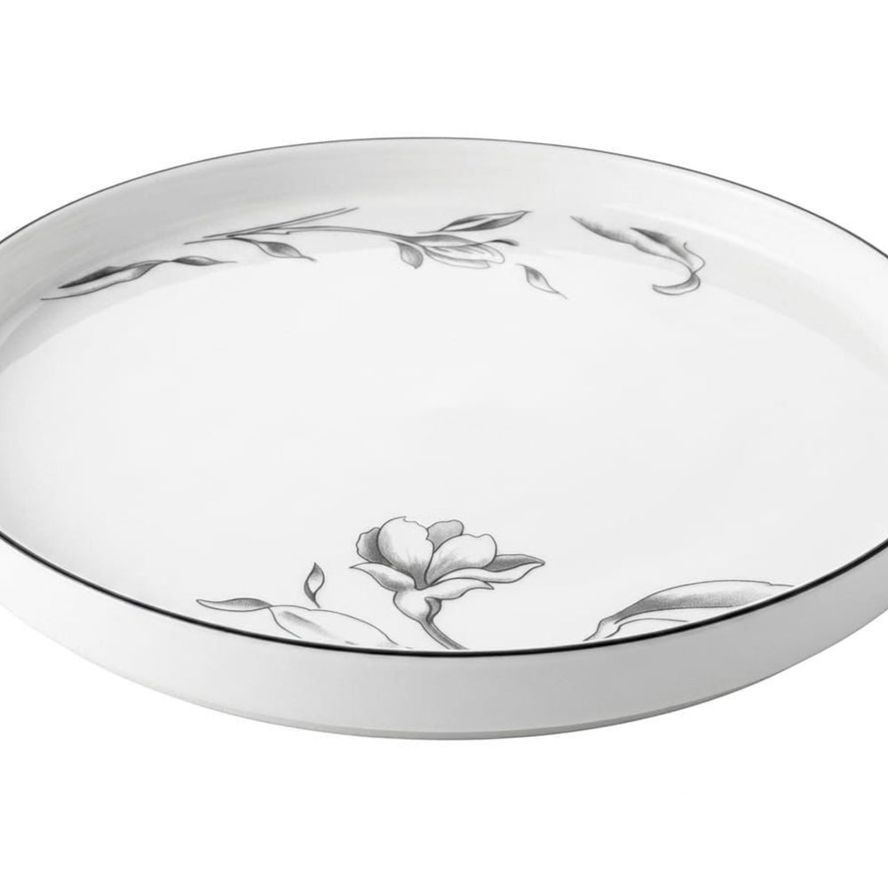 Home Sajawat white porcelain serving platter with delicate floral design and black trim.